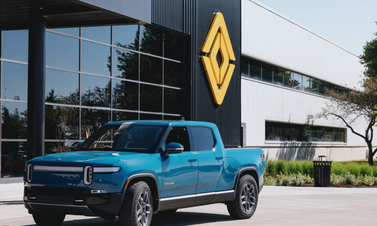 truck in front of building with rivian logo rivian