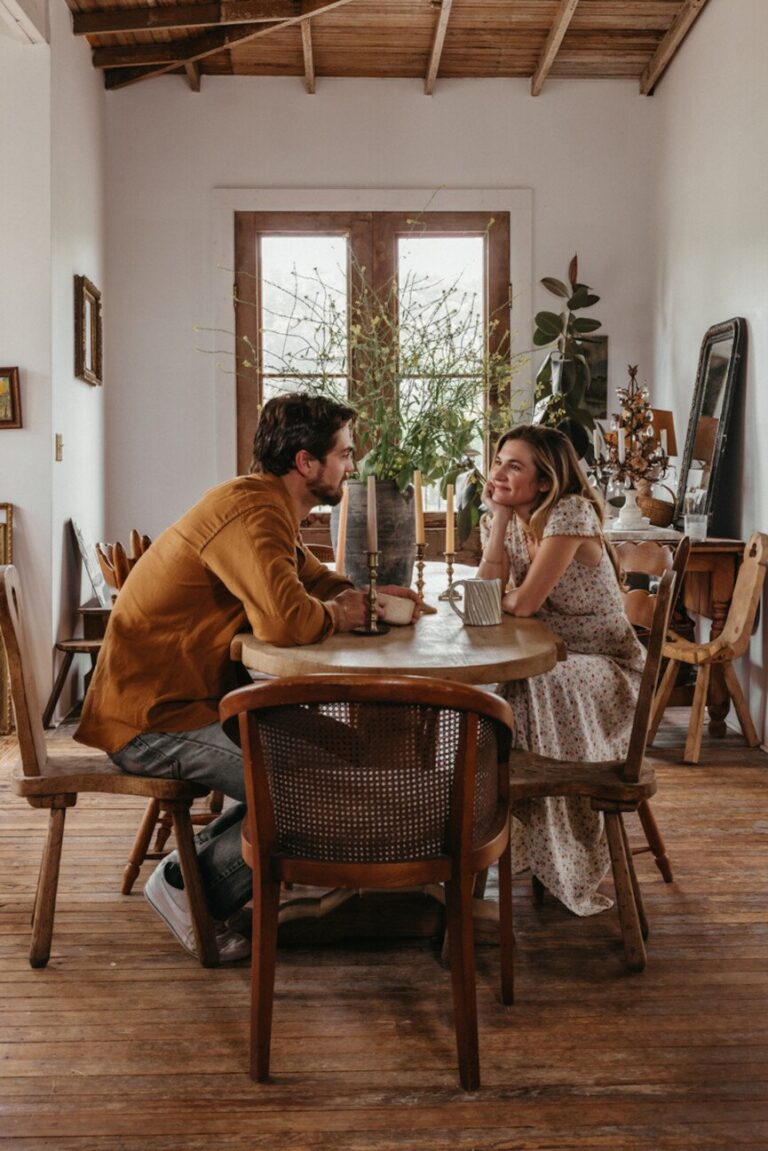 couple sitting at table 865x1296