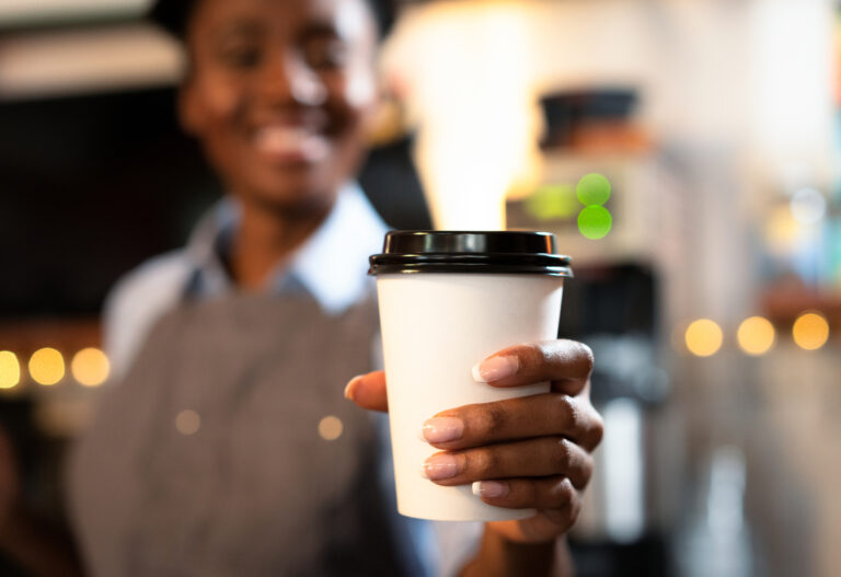 23 12 20 a person holding out a coffee cup mf dload gettyimages 1138882647 1167x800 58b30fa