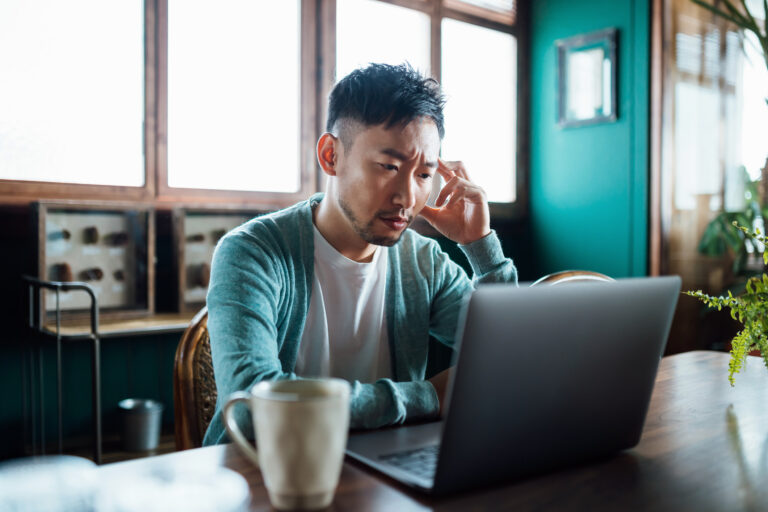 concerned unhappy person staring at laptop 1