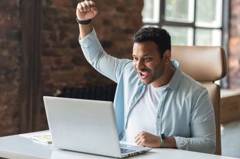 happy businessperson at their computer