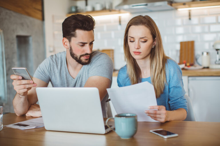 young couple looking over finances at home