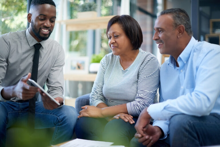 an advisor showing a tablet to a couple