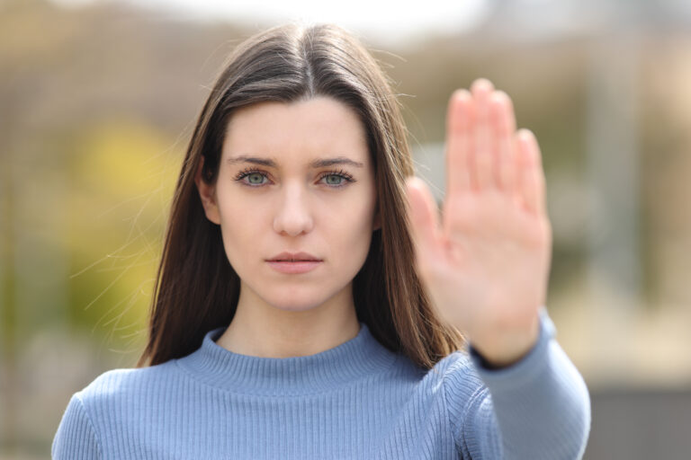 person with hand outstetched signaling negativity