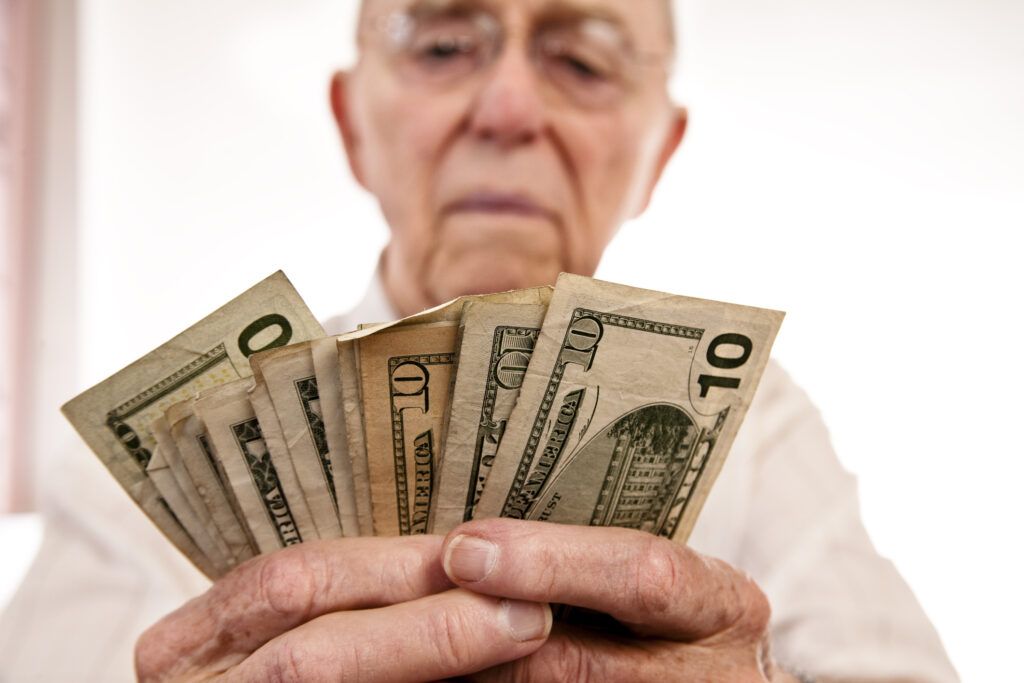 senior holding assortment cash bills social security retire getty