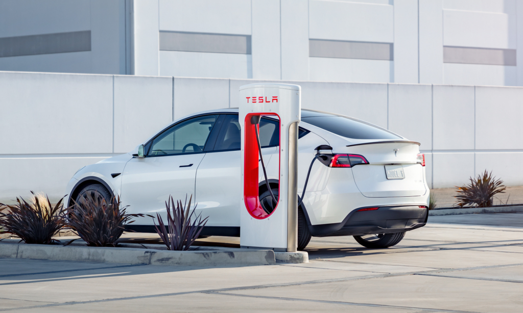 tesla car at super charger station