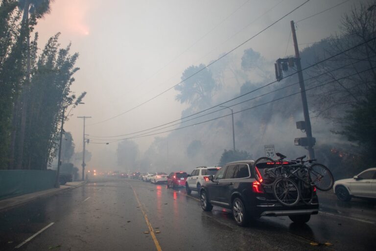 Cars evacuating L A fire