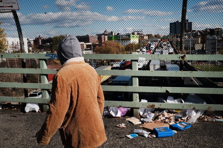 Man walks on littered overpass