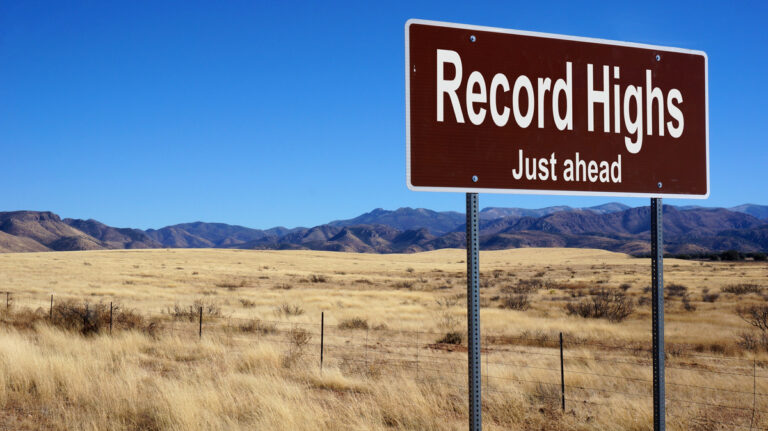 road sign reads record highs just ahead